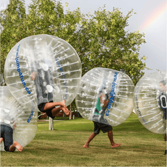 Soft Summits inflatable bumper ball in vibrant colors, showing a person inside the large, transparent inflatable bubble for outdoor fun.