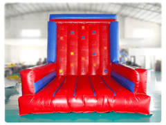 Red and blue inflatable climbing wall by Soft Summits with handholds, designed for easy setup and indoor or outdoor use.