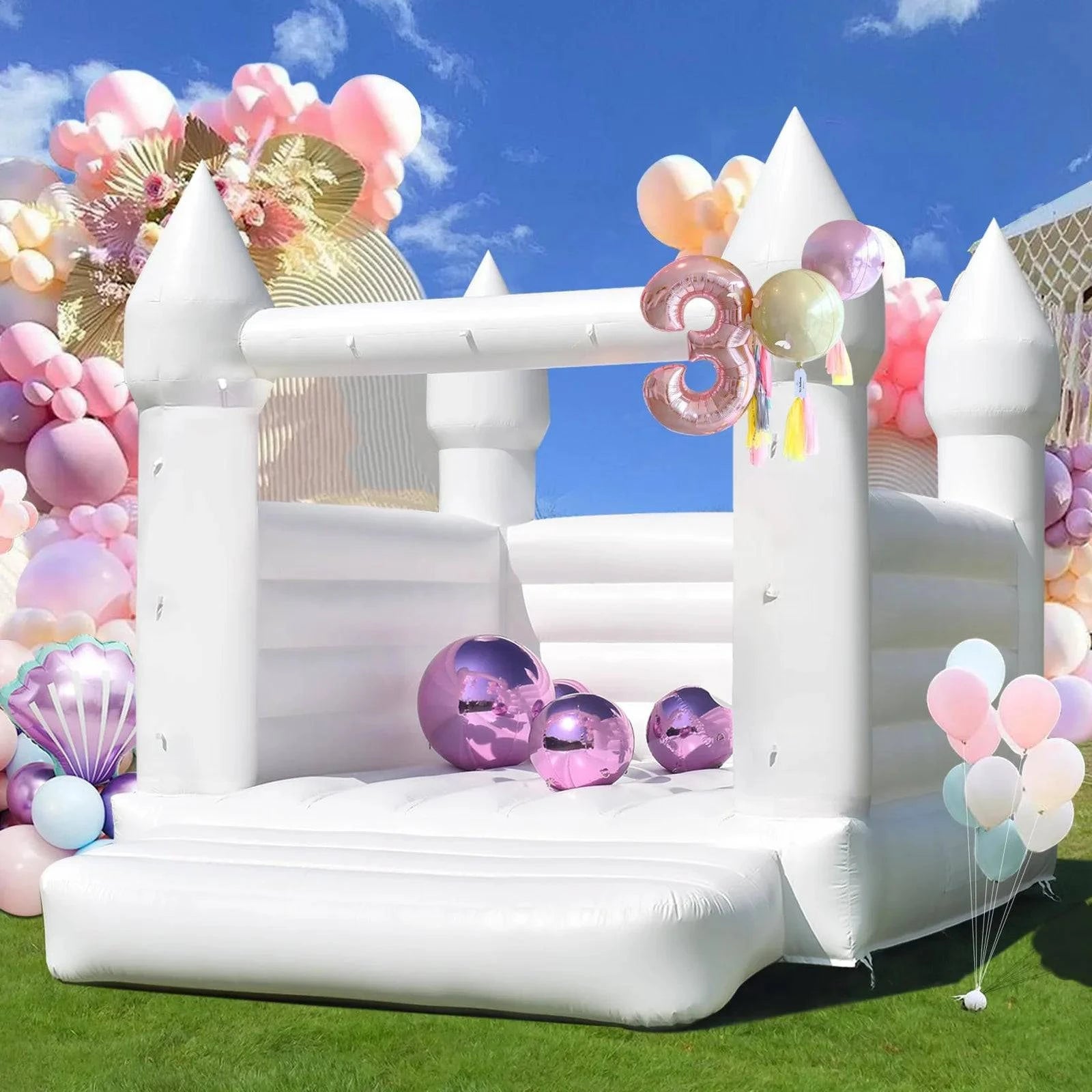White commercial grade PVC wedding bounce house by Soft Summits, inflatable structure for outdoor wedding celebrations.