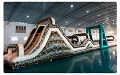 Soft Summits commercial size inflatable obstacle course with camouflage design, featuring multiple inflatable sections and vibrant colors.