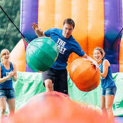 Kids having a blast on Soft Summits' commercial-size inflatable obstacle course, designed for safe and exciting entertainment.