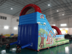 Back angle of Soft Summits commercial size PVC inflatable water slide with multiple sliding lanes and vibrant colors.