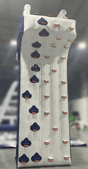Soft Summits inflatable climbing wall on boat or yacht, featuring colorful handholds and safety ropes for water-based climbing fun.
