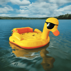 Soft Summits 5-seater inflatable duck boat on lake, giant towable pool toy with bright yellow duck design and seating area.