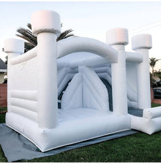 Soft Summits inflatable bounce house with slide, perfect for weddings and parties, featuring colorful bounce area and slide.