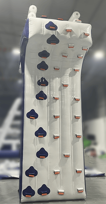 Soft Summits inflatable climbing wall installed on boat or yacht, featuring colorful handholds and climbing surface for water adventures.